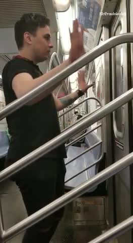 Guy in black opens subway doors with hands