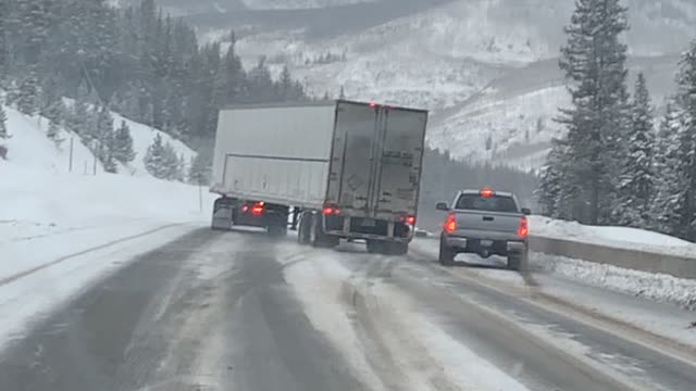 Semi Fishtailing Trying to Pass Vehicles on Icy Roads