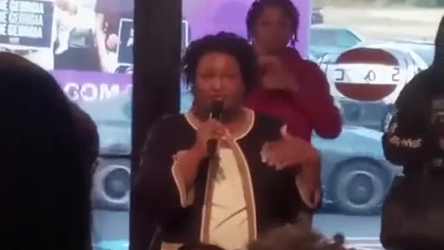 Stacey Abrams while in a crowded room maskless