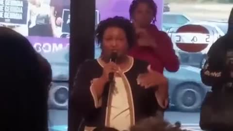 Stacey Abrams while in a crowded room maskless