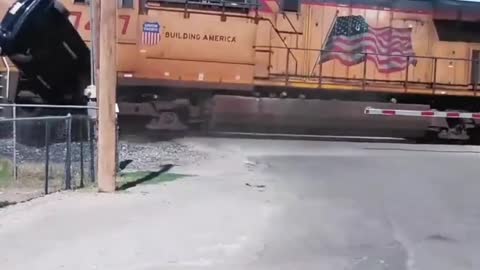 Train hits car off of trailer