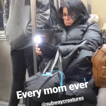 Mom using her phone on the subway accidentally leaves her flashlight on