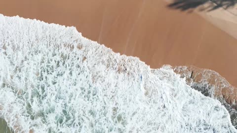 drone footage of Sea waves crashing on seashore