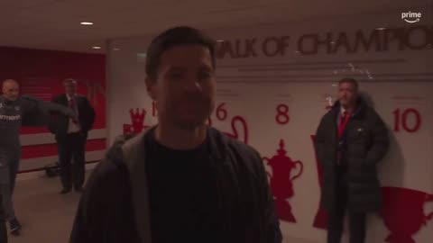 Xabi Alonso touches the Anfield sign