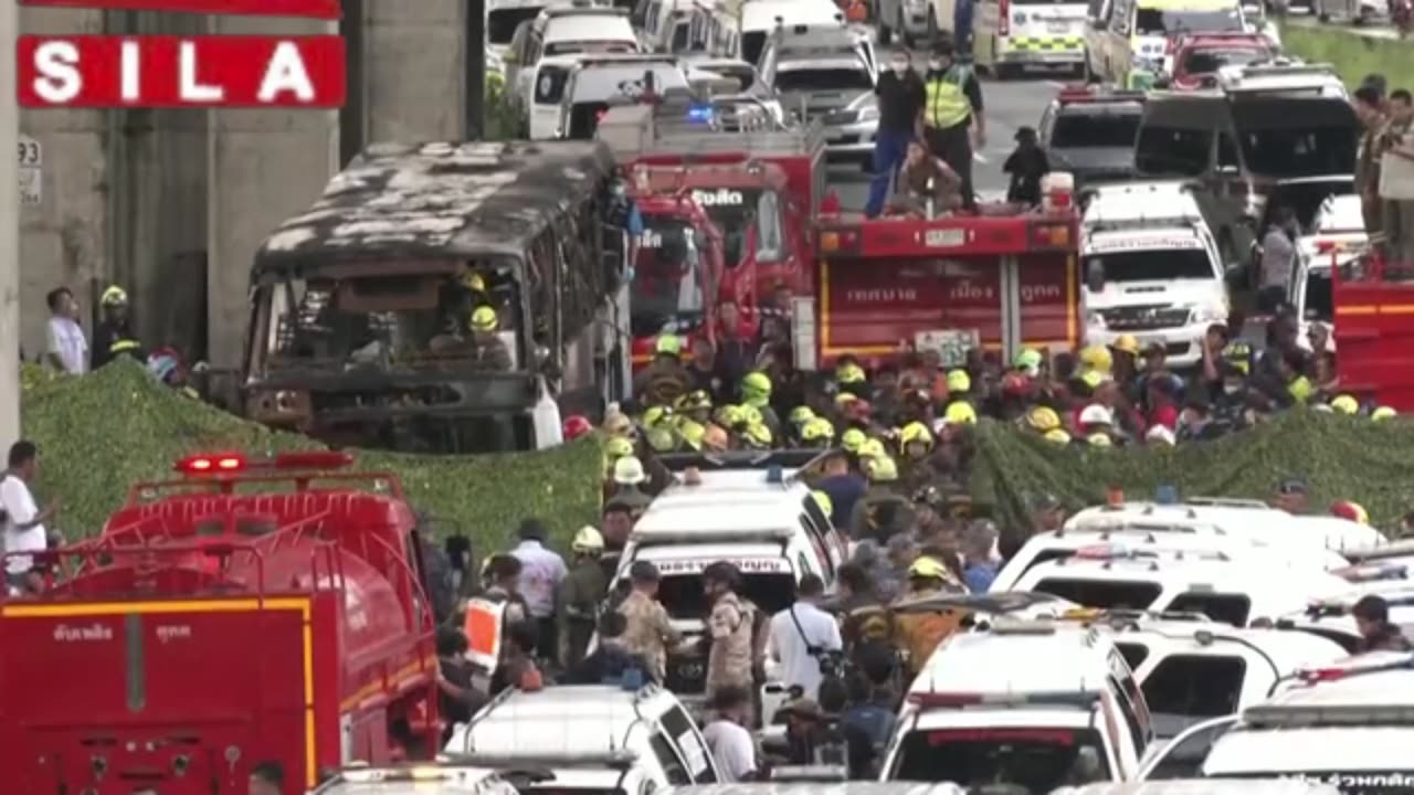 Rescue workers inspect inside burnt-out school bus in Thailand