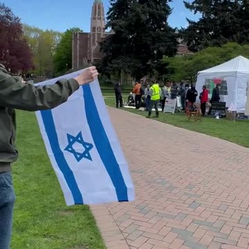 TPUSA chapter student at the U of Washington waves Israeli Flag at Hams Supporters
