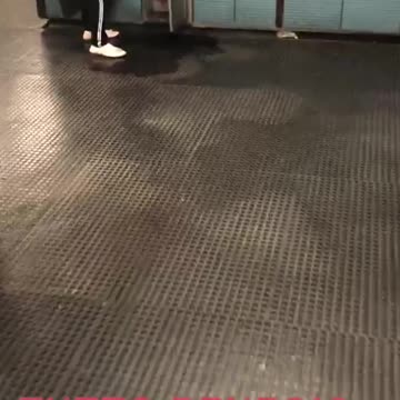 Woman denim jacket fills balloon with water