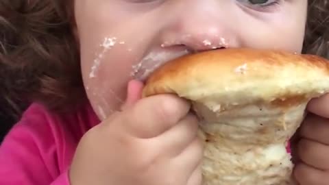 Cute Toddler Eating a Messy Pastry