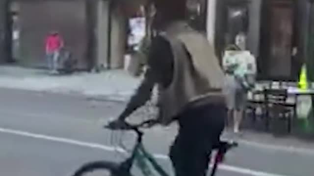 Man balances suitcase on his head while cycling in US. Watch video