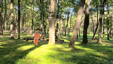 A cute baby playing in a beautiful forest