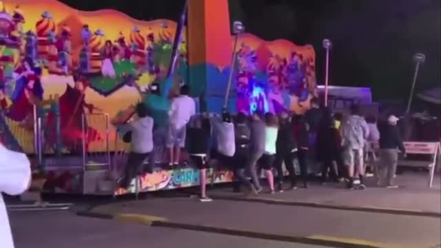 Carnival ride malfunctions, people run to prevent it from tipping over