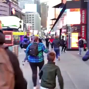 RUNNING IN FEAR: Tourists sent scrambling in Times Square after 'huge bang' reported