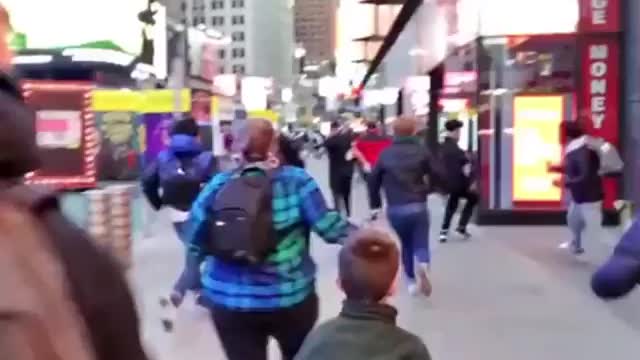 RUNNING IN FEAR: Tourists sent scrambling in Times Square after 'huge bang' reported