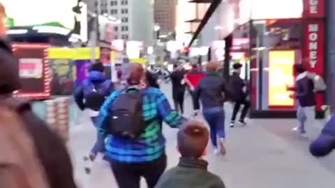 RUNNING IN FEAR: Tourists sent scrambling in Times Square after 'huge bang' reported