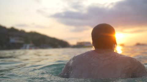 The back of a man diving