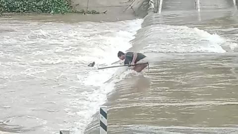 Man Rescues Drowning Dog From Flooding Road