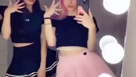 Two Beautiful Girls Dancing In Front Of The Mirror