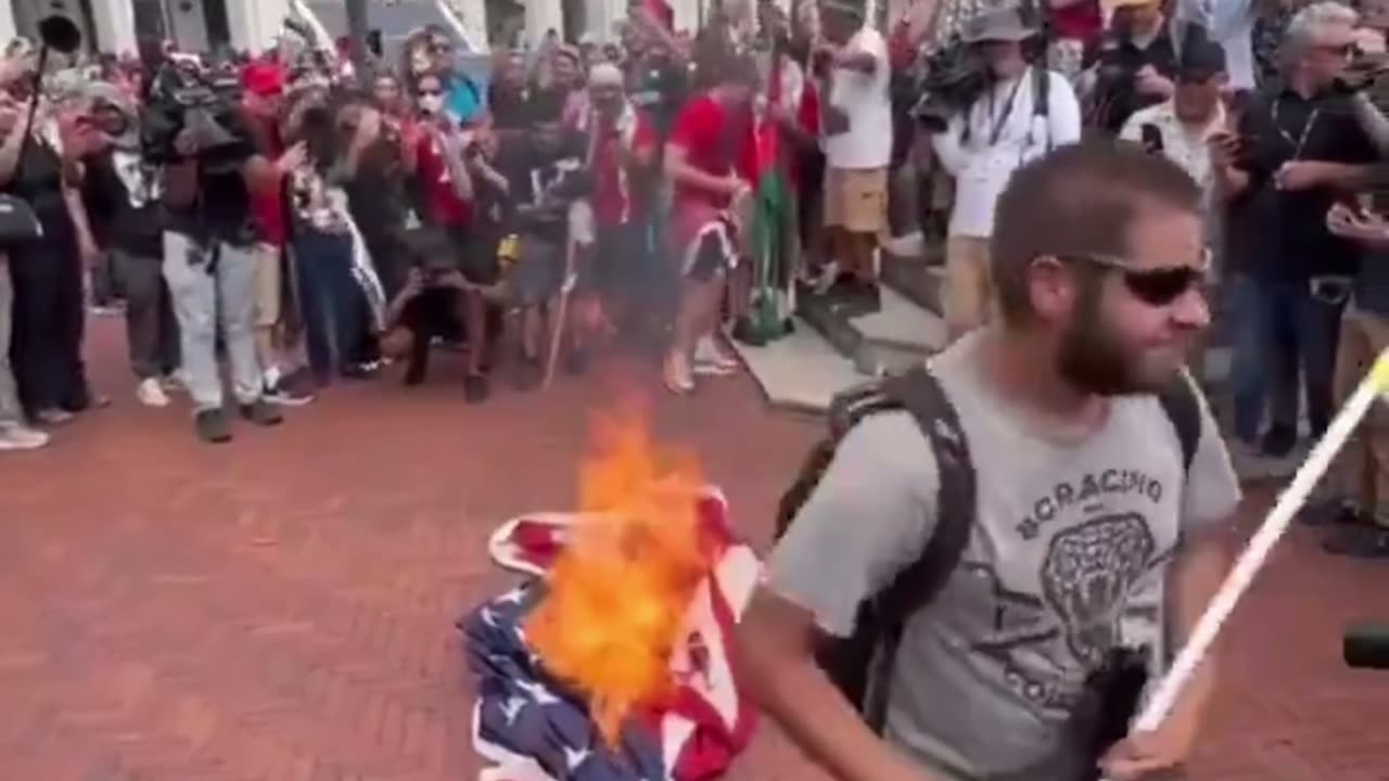 Anti-Israel rioters take down three US flags, burn them, and raise the Palestinian flag in D.C.