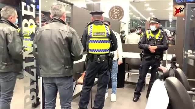 In Hamburg, Germany police enter a business to check if they are compliant with COVID restrictions