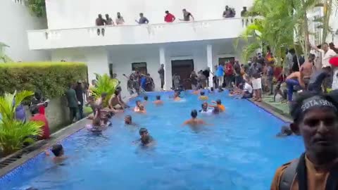 Sri Lankans enjoying the presidential pool after storming the palace.