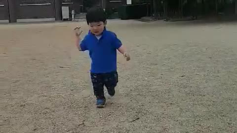 This is a video of a baby running hard on the playground.