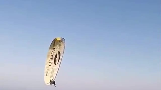 Two parachutes pull up a rope