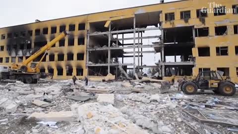 Ukrainian soldiers search through rubble in Okhtyrka after apparent Russian shel