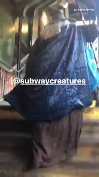 Person dressed as a wizard walking up stairs to train