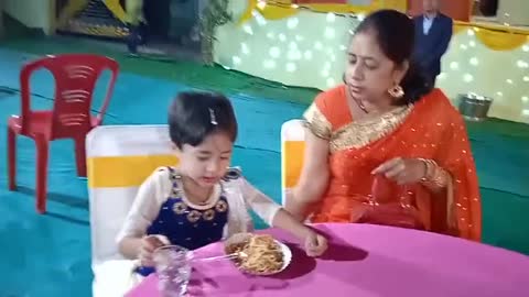 Cute little Girl enjoying food with her Mother