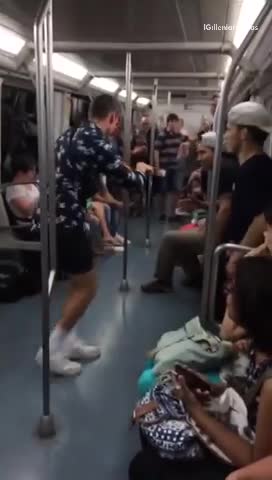 Guy blue button up shirt white shoes dancing on subway train