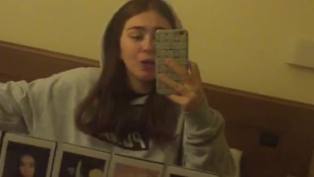 Girl singing to mirror selfie sees spider on the wall