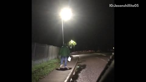 Car following guy in green jacket