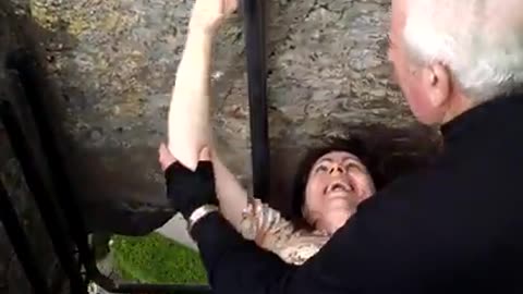 Kissing the Blarney Stone at Cork, Ireland