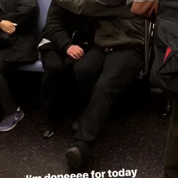 Guy black beanie green jacket trying to comfort and kiss lady black jacket