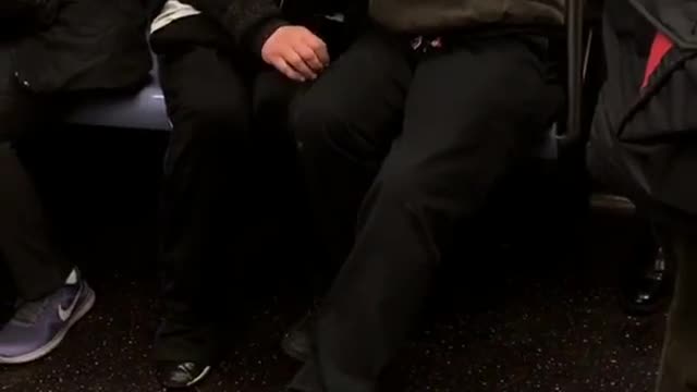 Guy black beanie green jacket trying to comfort and kiss lady black jacket