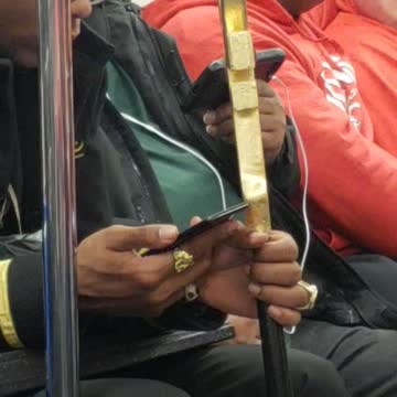Gold shoe man has flute cane in subway