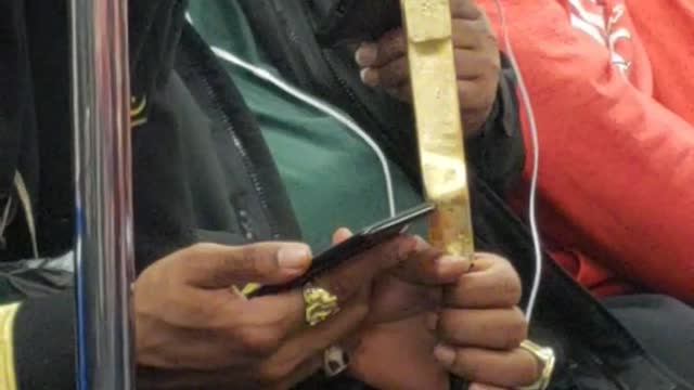 Gold shoe man has flute cane in subway