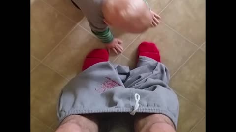 Baby пantses father while learning to walk