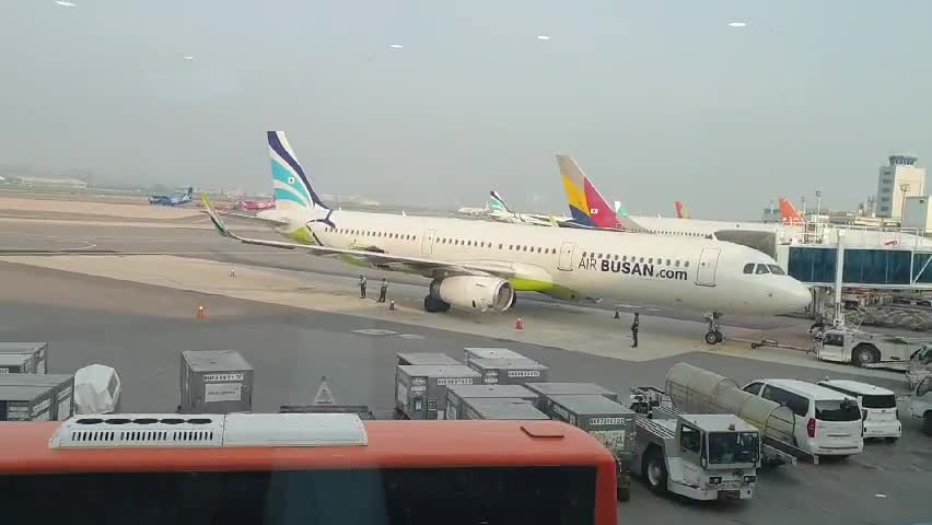 It is an airport in Korea. Various planes are waiting for departure