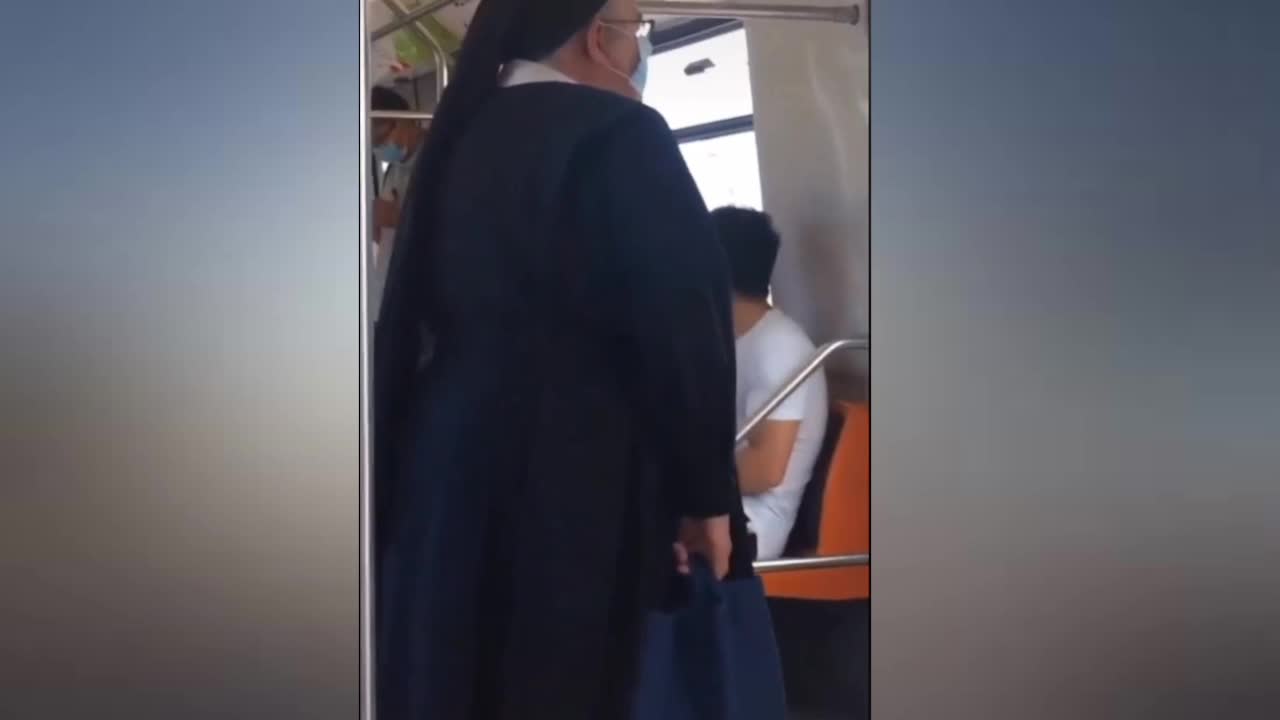 Two girls dancing on a public bus