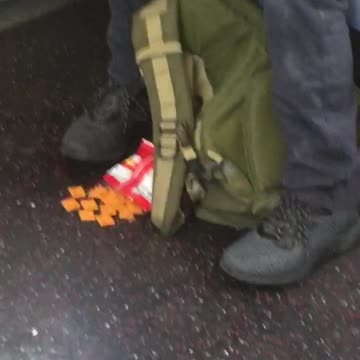 Man sleeps cheezits on floor in front of him