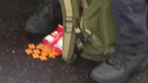 Man sleeps cheezits on floor in front of him