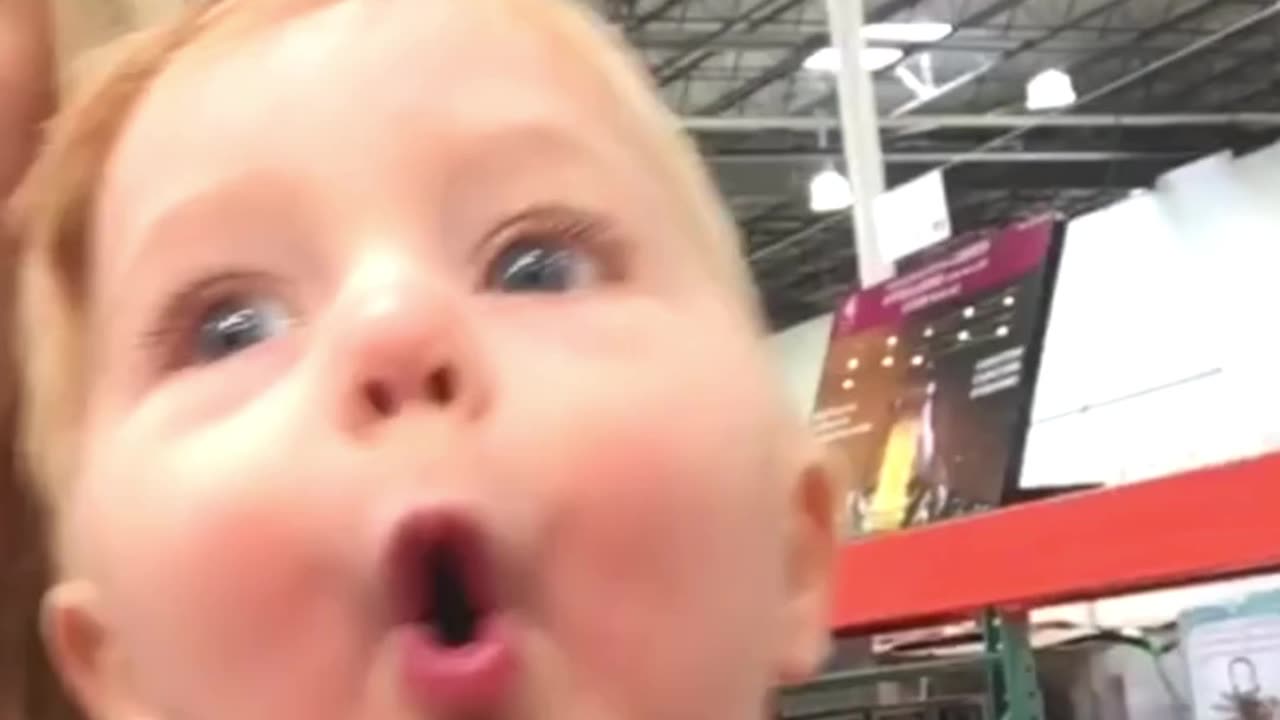 Little Boy Is Amazed by the Store's Christmas Decorations