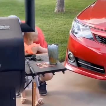 The father and the child install something next to the car