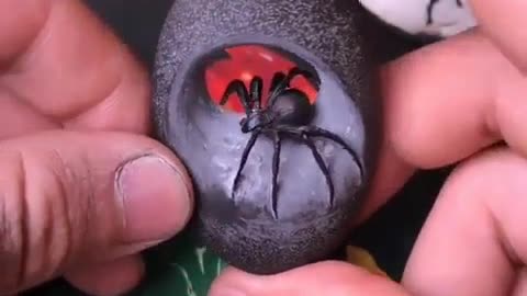 Carving a river stone into a Black Widow