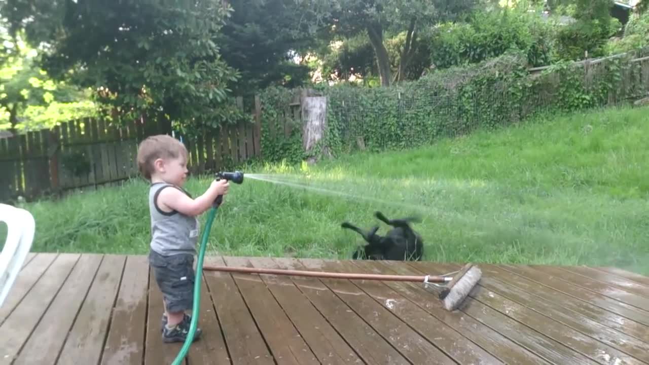 Two friends playing with water and having fun. Too Funny.