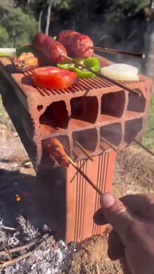 Cooking sausages on a fire in a brick