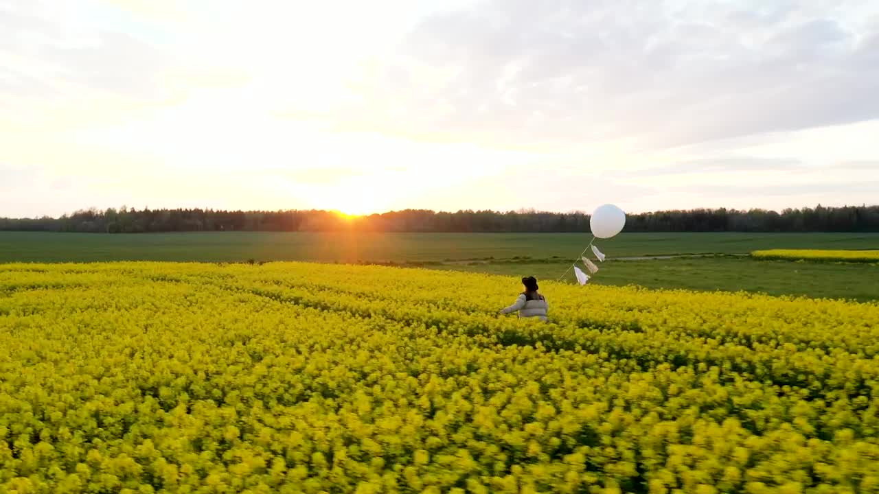 Walking on a flower field with a white balloon at sunset