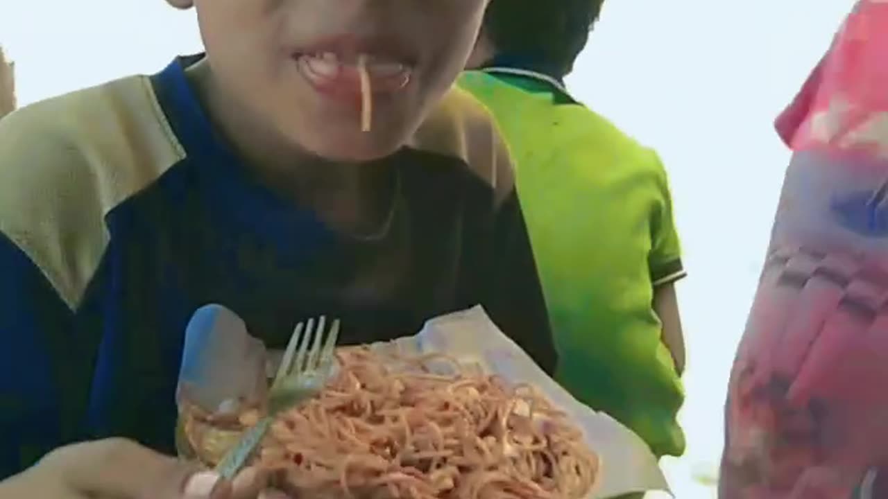 Little kids eating noodles