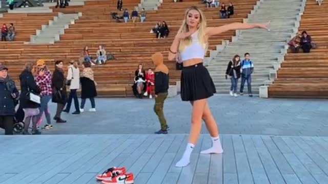 My little sister is dancing in the square